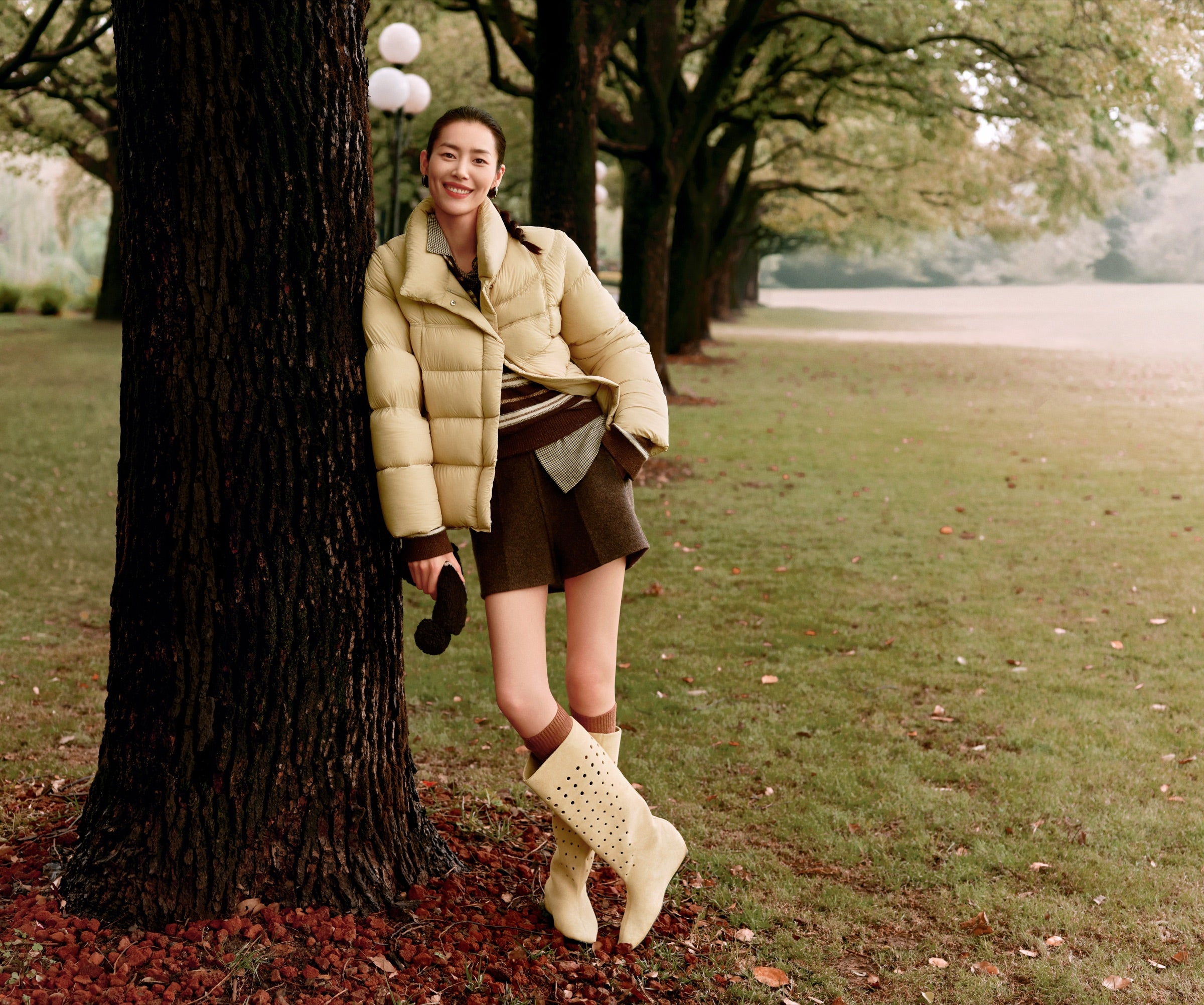DAZZLE campaign look in a tree-lined park