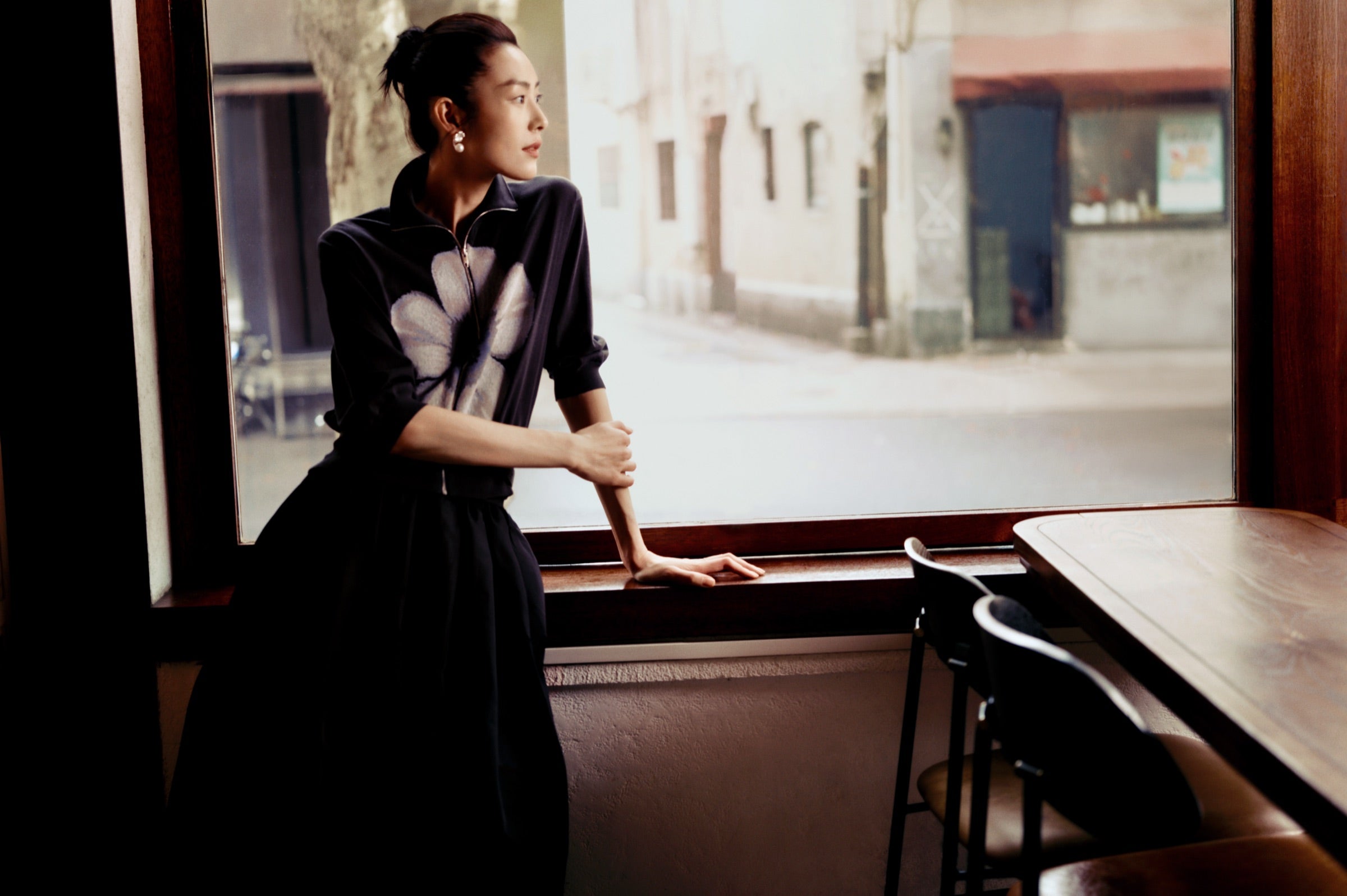DAZZLE campaign portrait by a city window